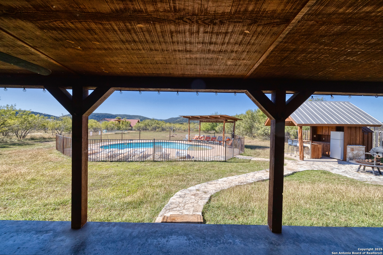 38 Mountain Laurel Lane Concan, TX 78838 - Photo 23 of 48 a view of a swimming pool with a patio