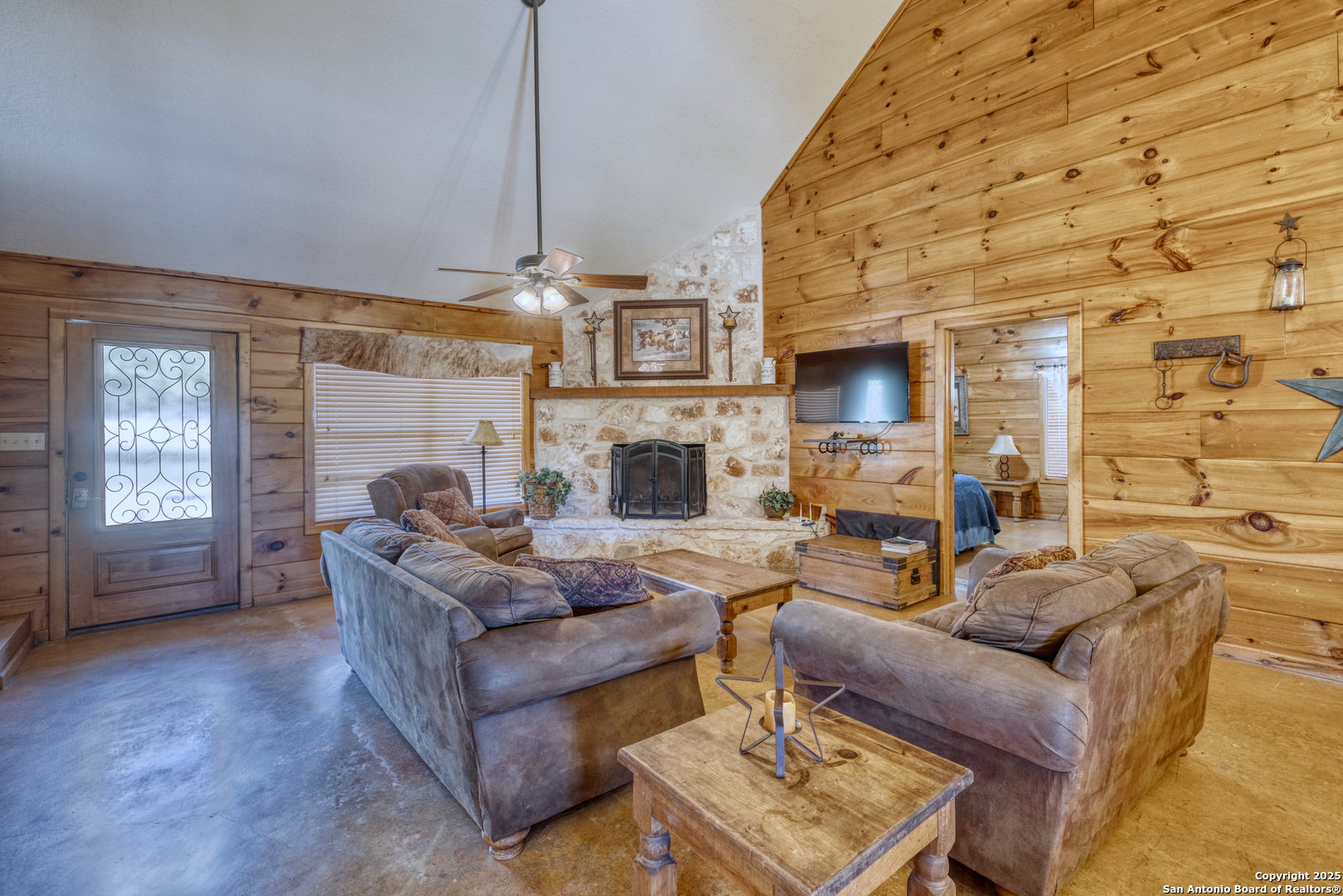 38 Mountain Laurel Lane Concan, TX 78838 - Photo 25 of 48 a living room with furniture a fireplace and a flat screen tv