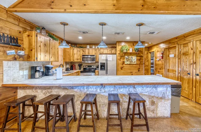 a large kitchen with a table and chairs in it