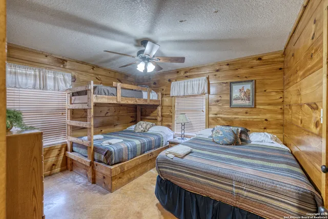 a bedroom with bed and a chandelier