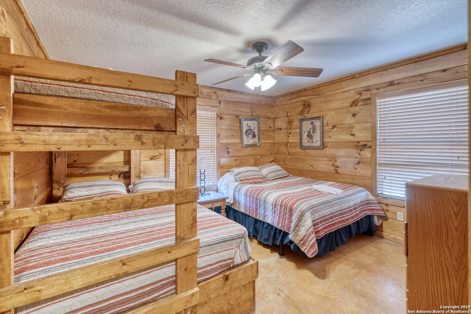 38 Mountain Laurel Lane Concan, TX 78838 - Photo 31 of 48 a spacious bedroom with a bed and a chandelier