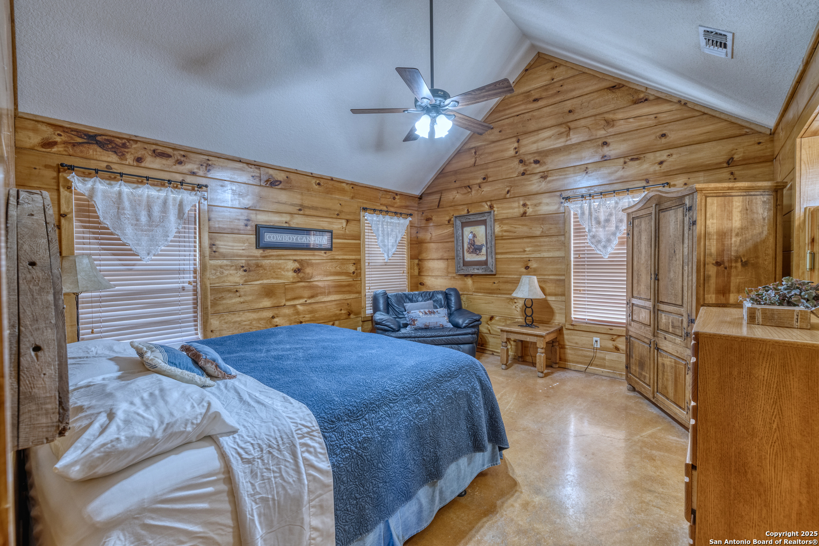 38 Mountain Laurel Lane Concan, TX 78838 - Photo 33 of 48 a bedroom with a large bed and a chandelier