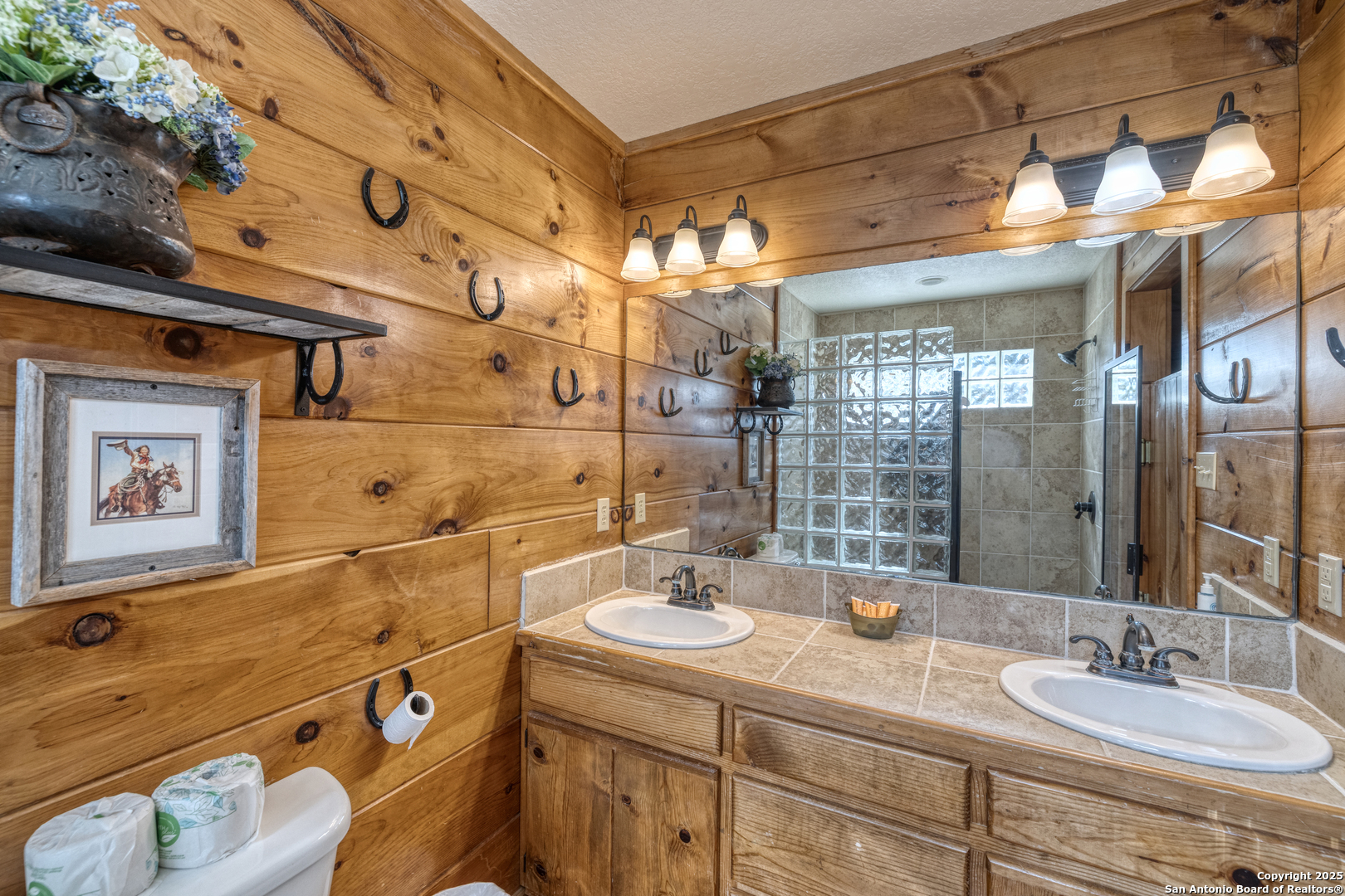 38 Mountain Laurel Lane Concan, TX 78838 - Photo 35 of 48 a bathroom with a sink double vanity and a mirror
