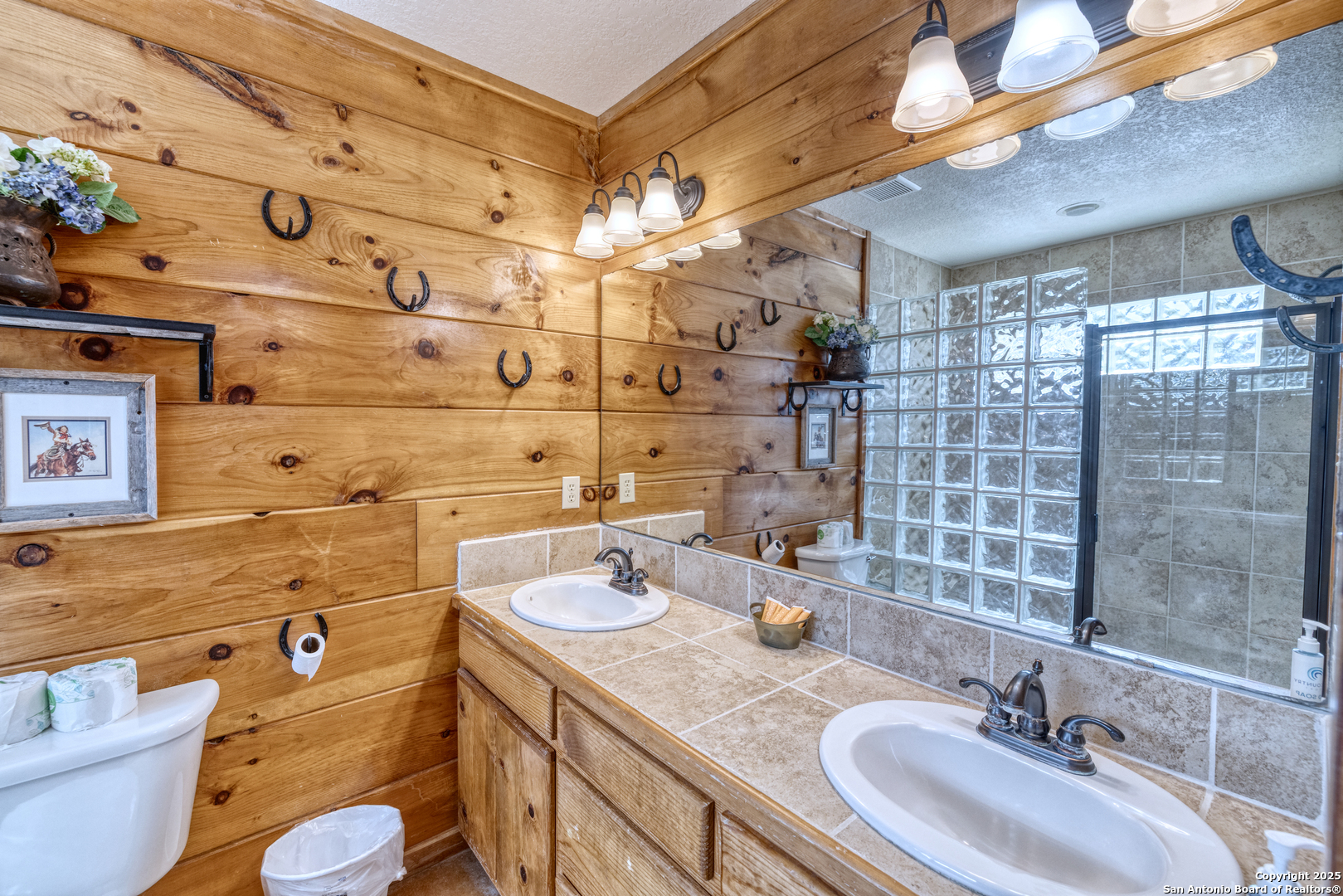 38 Mountain Laurel Lane Concan, TX 78838 - Photo 38 of 48 a bathroom with a granite countertop sink and a mirror