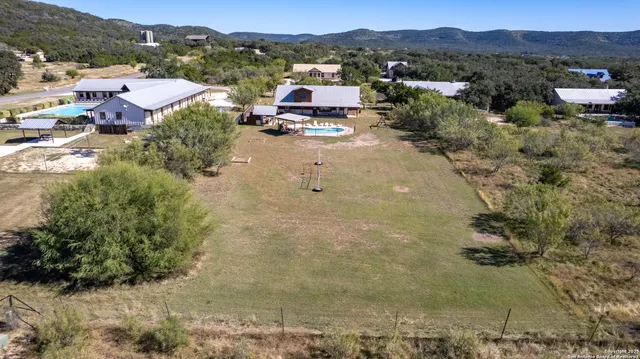 a view of a house with swimming pool and sitting area