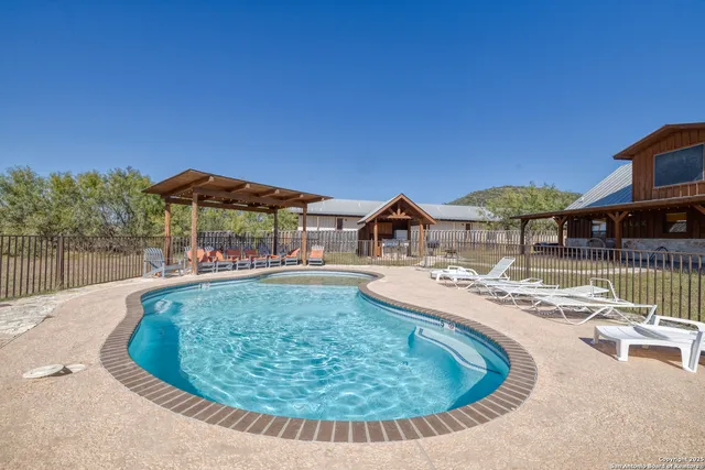 swimming pool view with a seating space