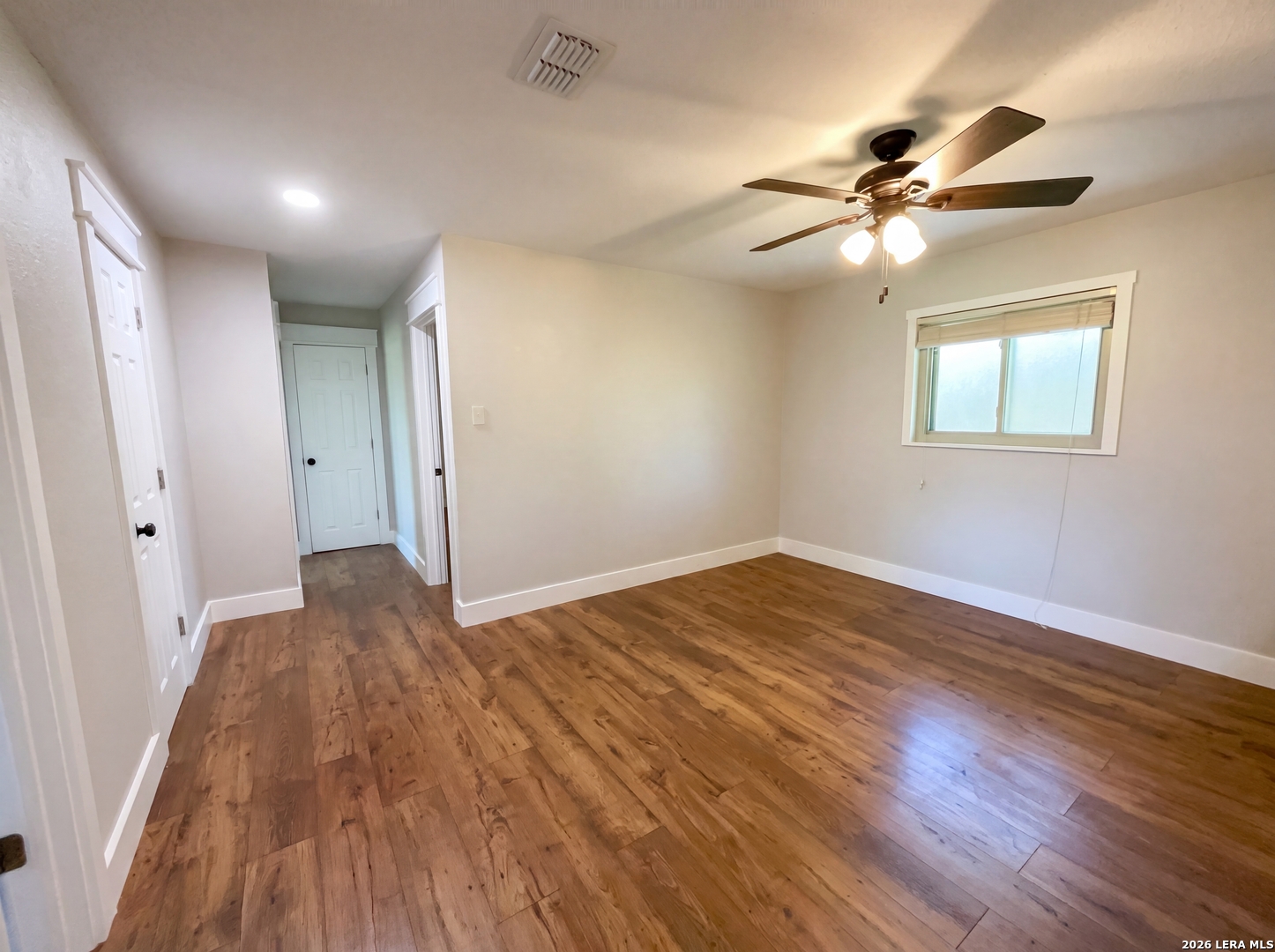 15422 Geronimo Loop San Antonio, TX 78254 - Photo 4 of 21 a view of empty room with wooden floor and fan