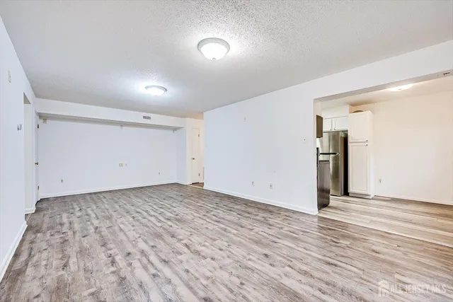 a view of a room with wooden floor and window