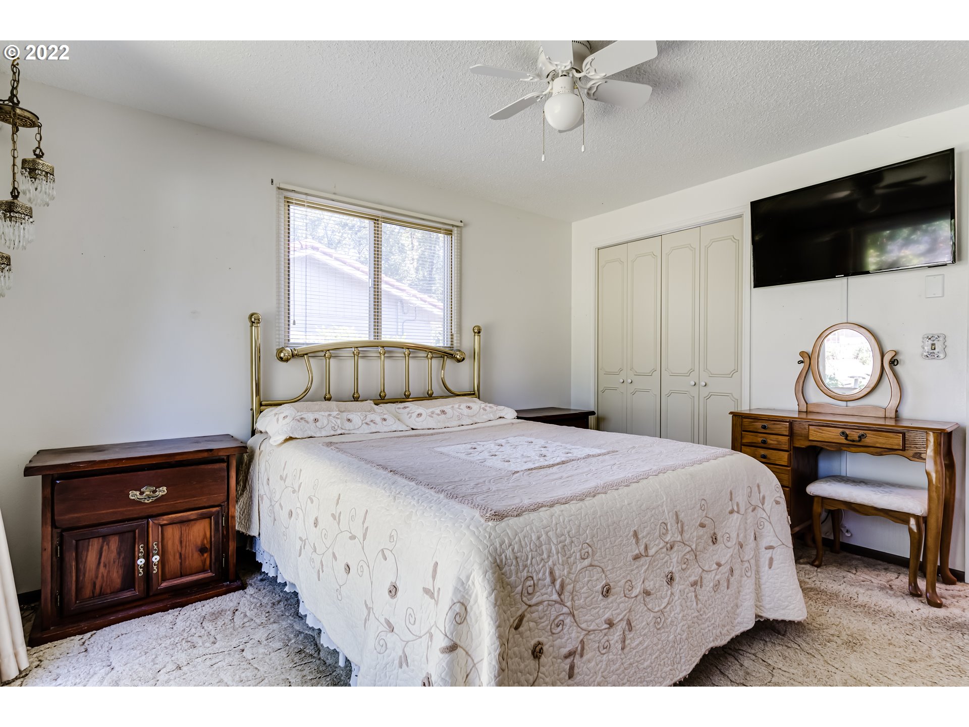 37833 Camp Creek Road Springfield, OR 97478 - Photo 11 of 32 a bedroom with a bed a mirror on dresser and a window
