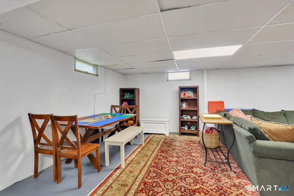 72 Old Post Road Wethersfield, CT 06109 - Photo 30 of 40 a living room with furniture and a book shelf