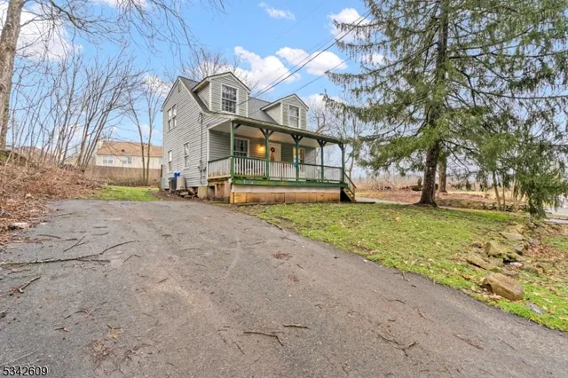 a view of a house with a yard and garage