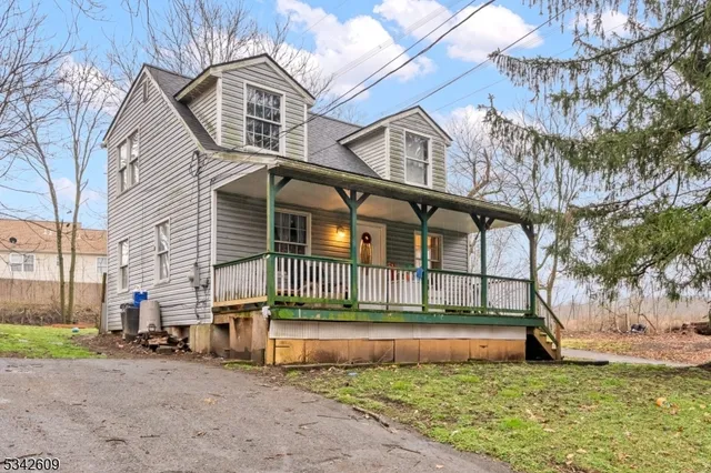 a view of a house with a large window and a yard
