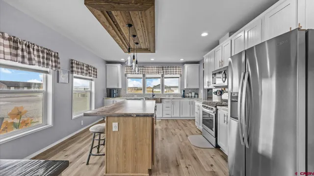 a kitchen with stainless steel appliances granite countertop a refrigerator and a sink