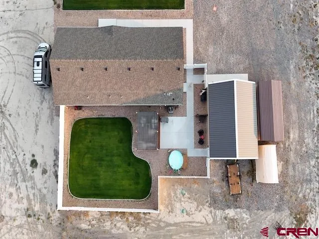a backyard of a house with table and chairs
