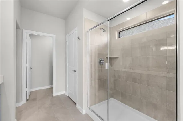 a bathroom with a shower and a sink