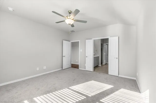a view of a livingroom with a ceiling fan and window