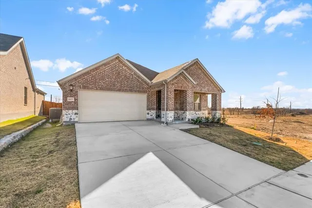 a view of a house with a yard and ocean view