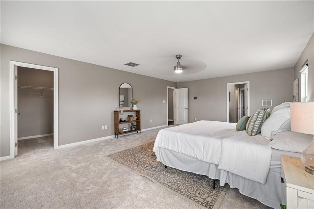 174 Cimarron Drive Coraopolis, PA 15108 - Photo 28 of 50 a bedroom with a large bed and a chandelier