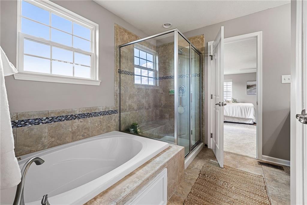 174 Cimarron Drive Coraopolis, PA 15108 - Photo 31 of 50 a bathroom with a tub a sink and a shower