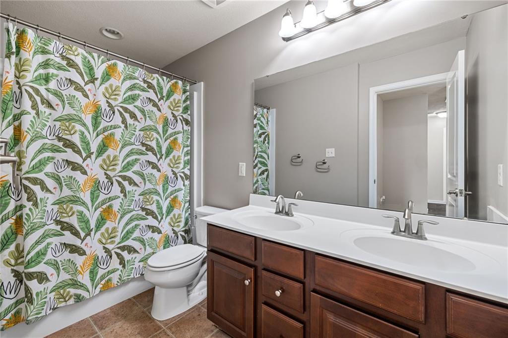 174 Cimarron Drive Coraopolis, PA 15108 - Photo 34 of 50 a bathroom with a granite countertop sink a toilet and a mirror