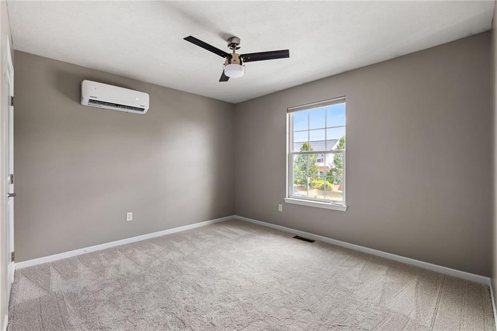 174 Cimarron Drive Coraopolis, PA 15108 - Photo 40 of 50 an empty room with windows and ceiling fan