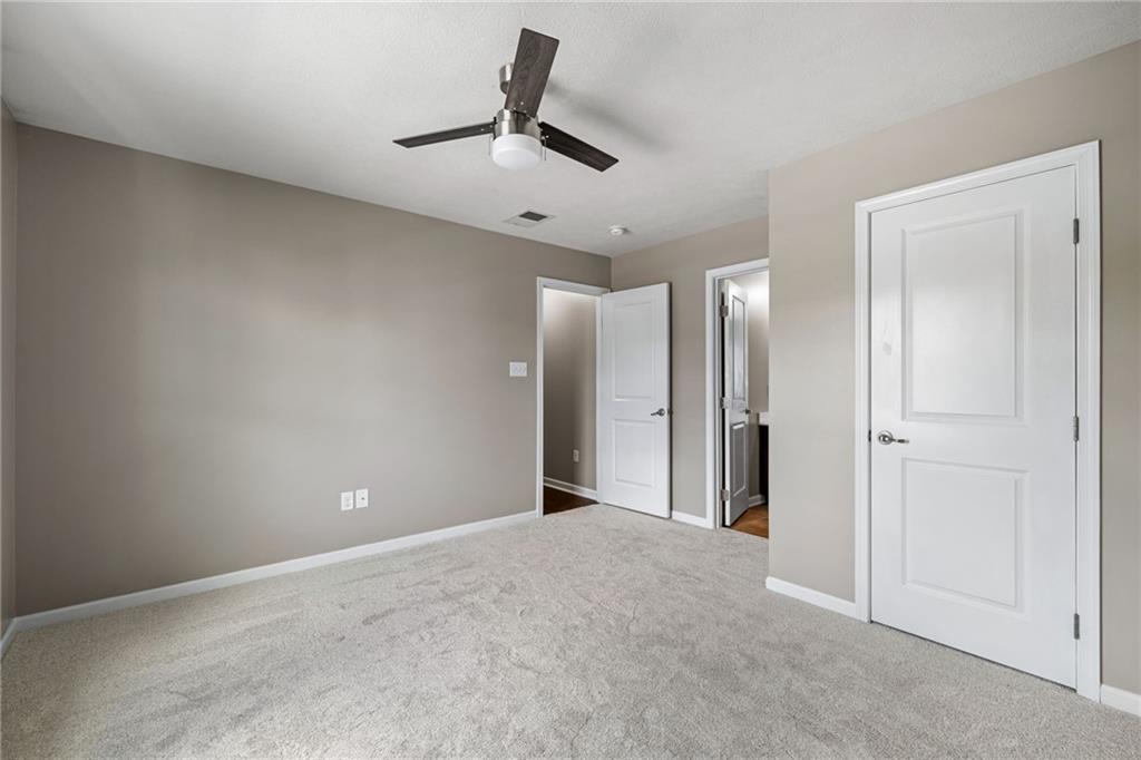 174 Cimarron Drive Coraopolis, PA 15108 - Photo 41 of 50 an empty room with a ceiling fan and bathroom