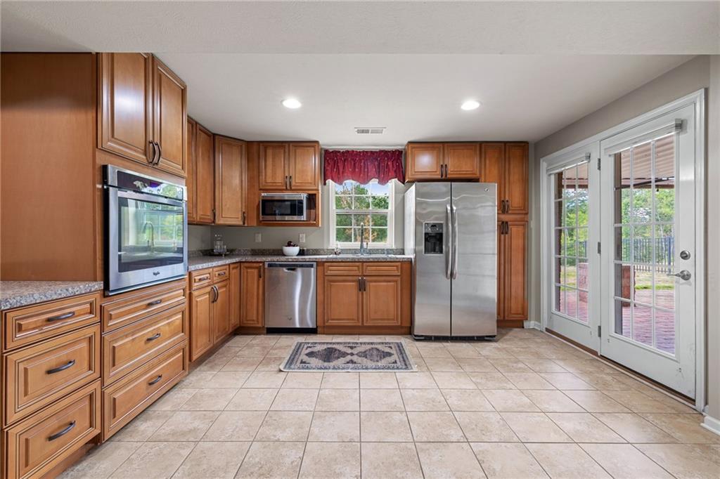 174 Cimarron Drive Coraopolis, PA 15108 - Photo 45 of 50 a kitchen with stainless steel appliances granite countertop a refrigerator and a stove top oven