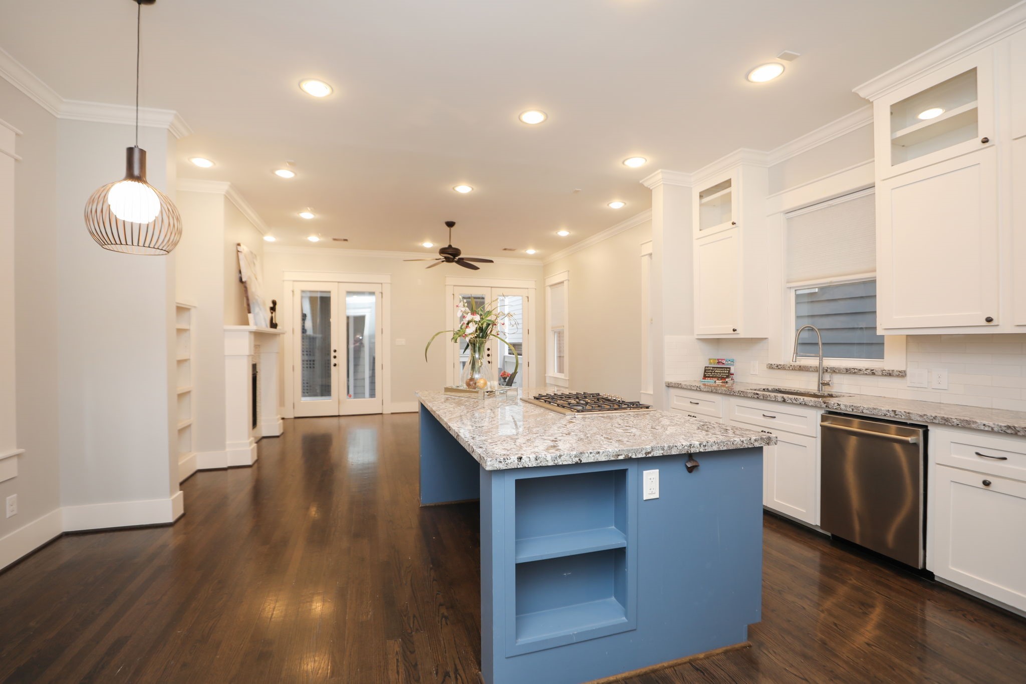 907 East 25th Street Houston, TX 77009 - Photo 9 of 32 Chef’s Island Kitchen with granite counter tops, wall to wall cabinetry and built-in shelves makes this kitchen VERY inviting! Great view of breakfast area and breakfast bar leads to the family room.