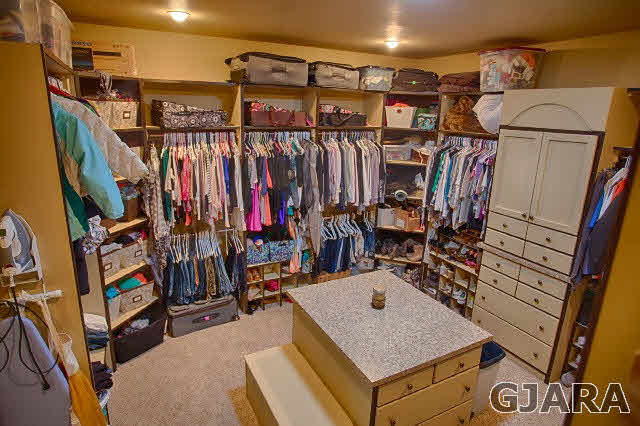 1140 23 Road Grand Junction, CO 81505 - Photo 3 of 13 a view of walk in closet with clothes and shoes