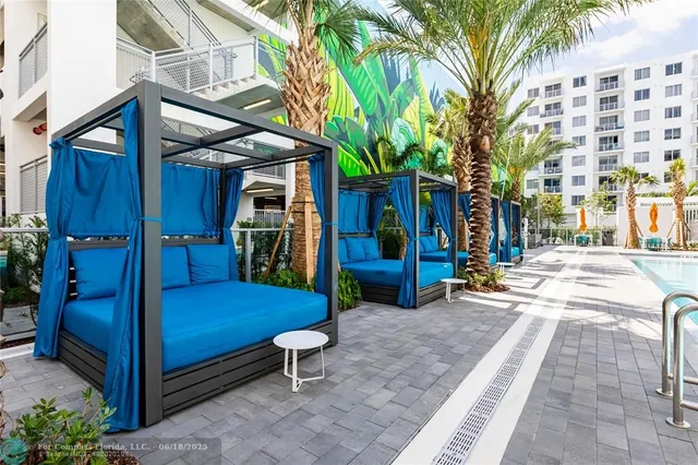 a backyard of a house with barbeque oven and outdoor seating