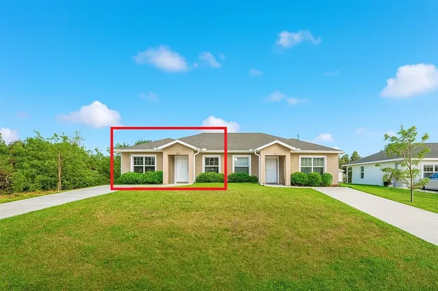 a front view of a house with a yard and trees