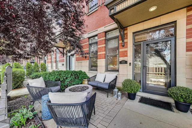 a view of a patio with couches table and chairs and potted plants