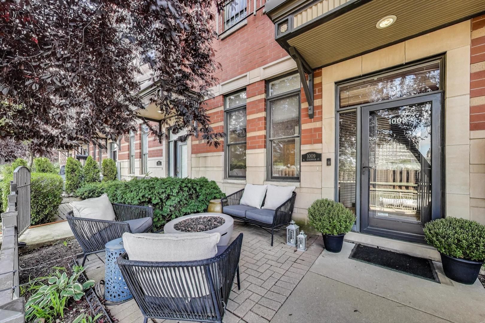 a view of a patio with couches table and chairs and potted plants