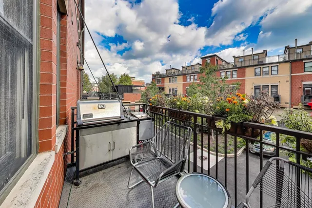 a kitchen with stainless steel appliances granite countertop a sink a stove a refrigerator a dining table and chairs with wooden floor