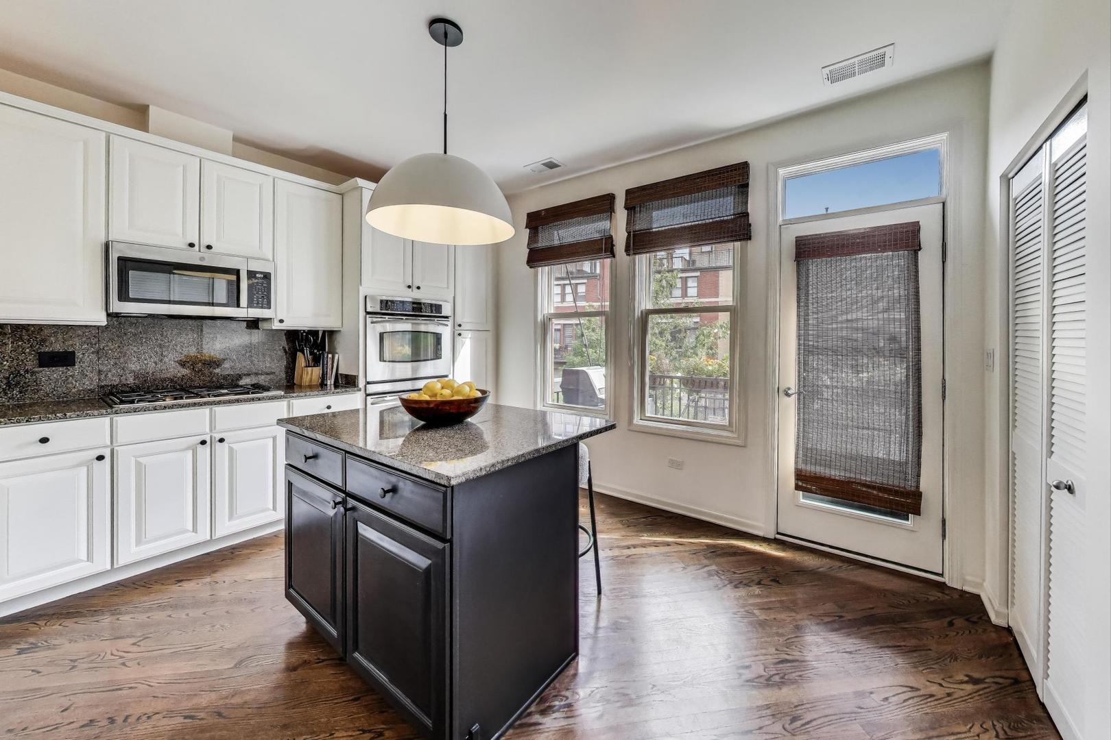 1009 North Riverwalk Street Chicago, IL 60610 - Photo 17 of 39 a kitchen with stainless steel appliances granite countertop a stove and a refrigerator
