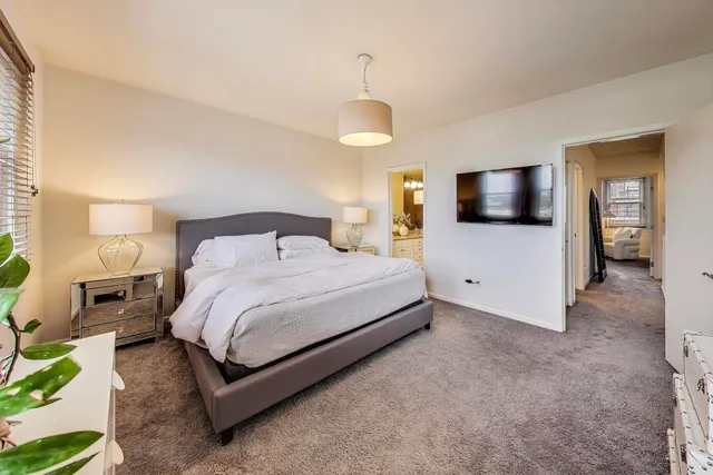 a bedroom with a bed and a view of bathroom