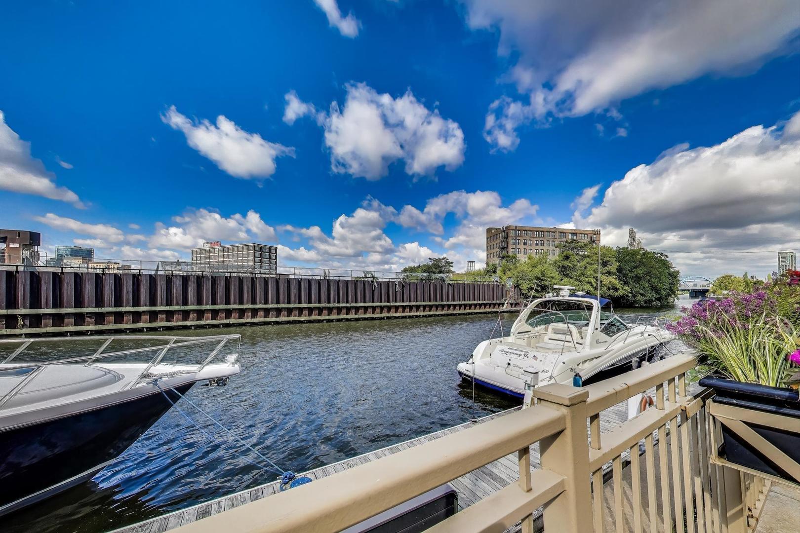 1009 North Riverwalk Street Chicago, IL 60610 - Photo 33 of 39 a view of a balcony with dining table and chairs with potted plants
