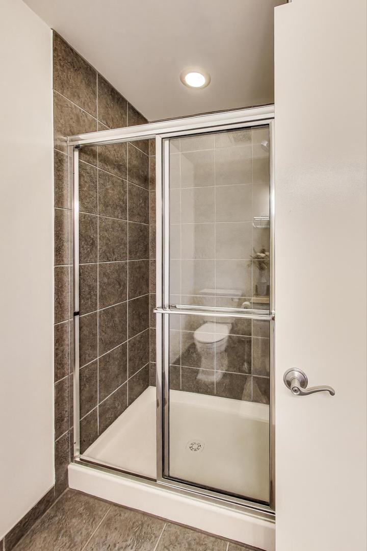 1009 North Riverwalk Street Chicago, IL 60610 - Photo 7 of 39 a bathroom with a glass shower door