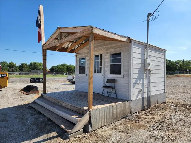 a front view of a house with garden and patio