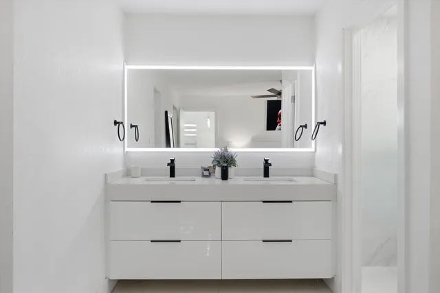 a bathroom with a double vanity sink and mirror