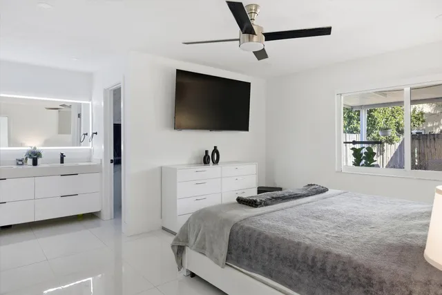 a bedroom with a bed and a flat screen tv