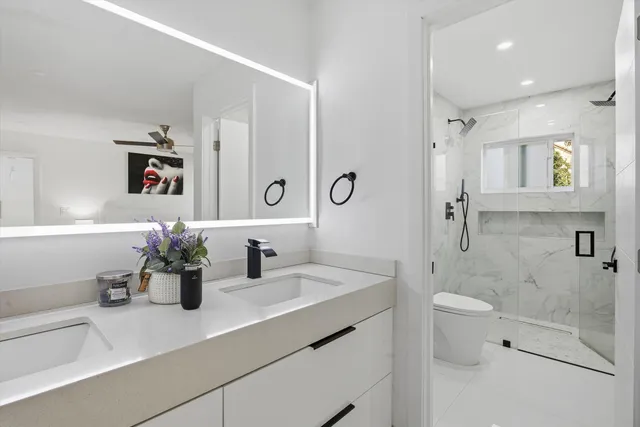 a bathroom with a sink a large mirror and shower