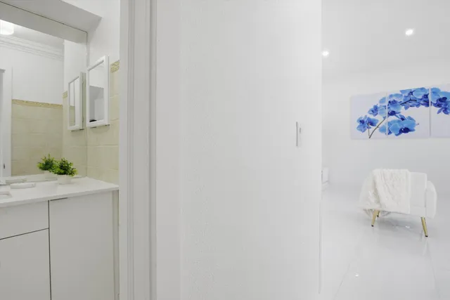 a bathroom with a window and a chair