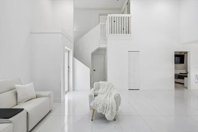 a living room with furniture and white walls