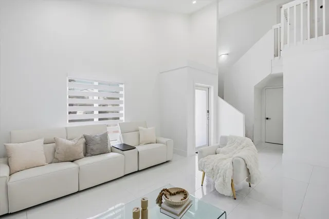 a living room with furniture and a large mirror