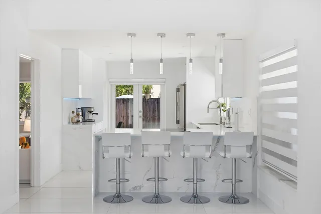 a view of kitchen with refrigerator and window