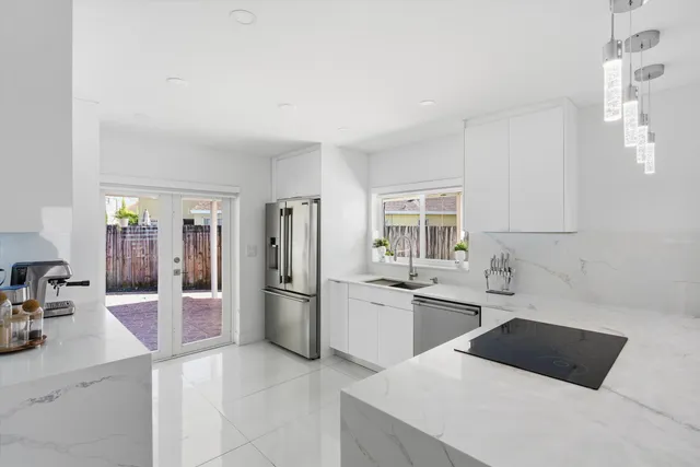 a kitchen with a sink and refrigerator
