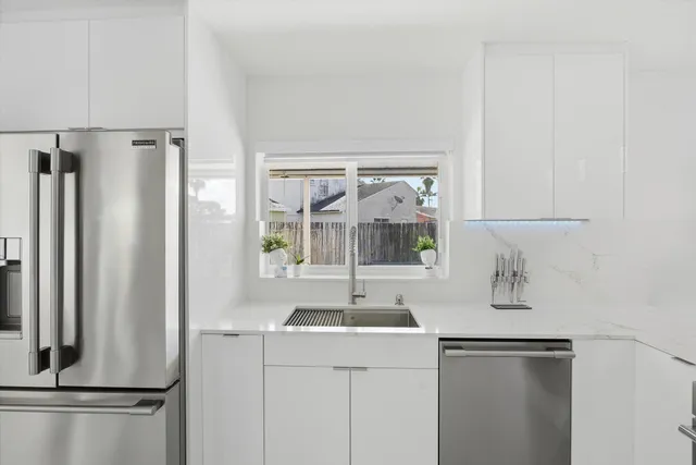 a kitchen with a refrigerator and a sink
