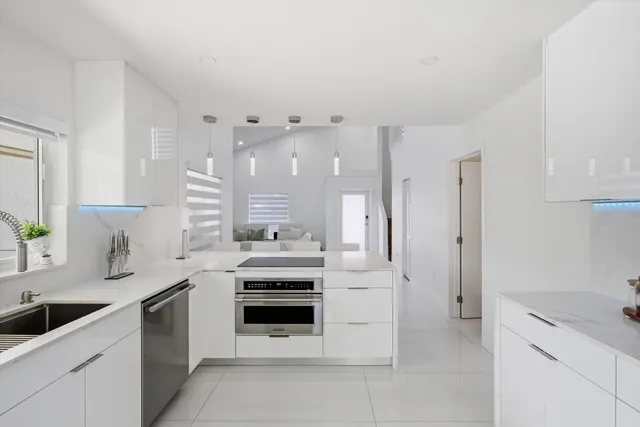 a kitchen with stainless steel appliances granite countertop a sink and cabinets