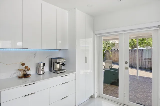 a kitchen with a sink and glass door